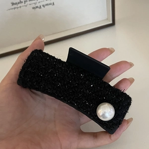 Elegant black tweed claw clip with large pearl accent for French style hair styling
