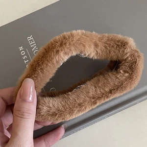 Detail shot of the plush faux fur texture on a brown claw clip with transparent teeth