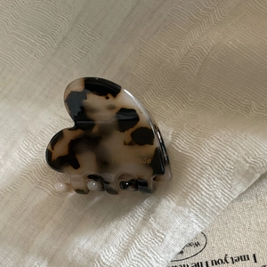 French heart-shaped acetate hair claw clip with leopard pattern and pearl details