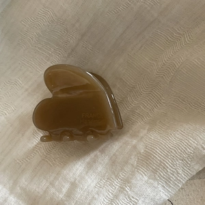 Detailed side view of dark amber acetate hair claw clip showing France Handmade inscription