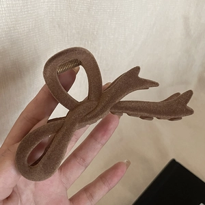 Vintage brown flocked bow hair claw clip for elegant bun hairstyles and daily hair accessories