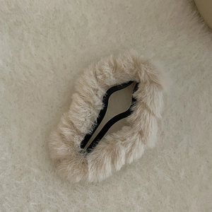 Close-up of soft beige plush BB hair clip with fluffy texture for autumn and winter styles