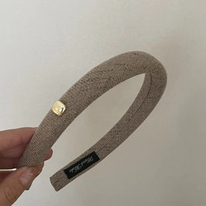 Detail of wool vintage headband showing khaki fabric texture and handmade label