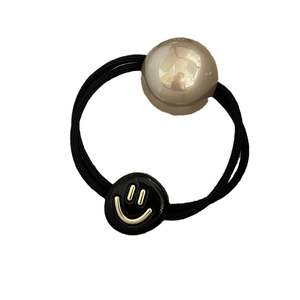 Elastic hair tie with a large silver mirror bead and a gold smiley face pendant
