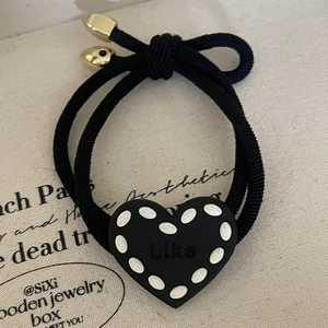Elastic black hair tie featuring a black heart charm with Like lettering and gold metal tips