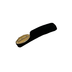 Vintage black velvet hair clip with oval gold metal handmade plate on white background