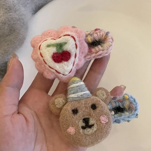 Cute handmade felt hair clips featuring a pink heart with cherry and a brown party bear