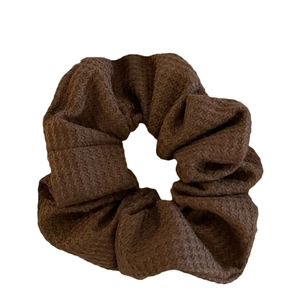 Brown fabric scrunchie with textured elastic design for voluminous hair styling