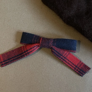 Plaid bow hair clip with red and blue pattern made of warm tweed fabric for winter