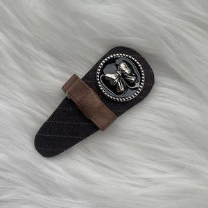 Detail of vintage coffee plaid suit fabric hair clip with butterfly decorative button