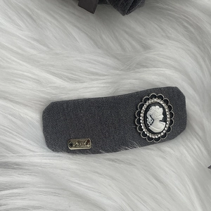 Detail of dark grey plaid hair clip with vintage cameo portrait and tiny rhinestones decor