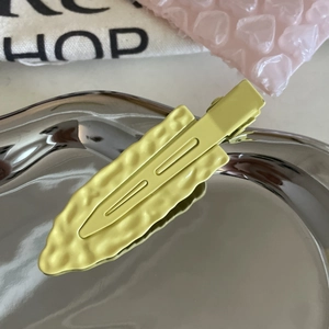 Minimalist textured candy color hair clips in pale yellow and light green finish