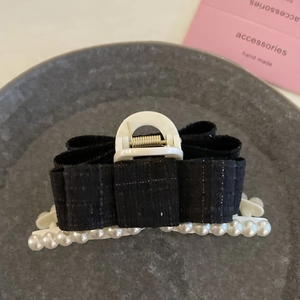 Elegant black tweed bow hair claw with white pearls and shimmering Hepburn style finish