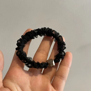 Elegant black organza scrunchie with metallic hexagonal bead for stylish hairstyles