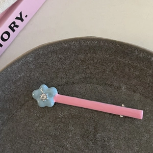 Nahaufnahme der rosa-blauen Stern-Haarklammer mit Strassstein in einer Keramikschale