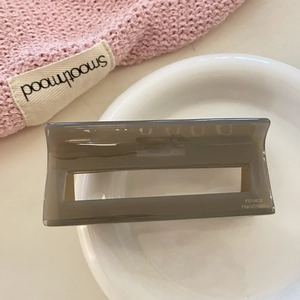 Detail of a large rectangular smoky grey cellulose acetate claw clip for hair styling