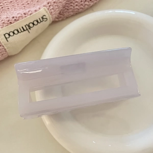 Elegant lavender square acetate hair claw clip for women on a white ceramic plate