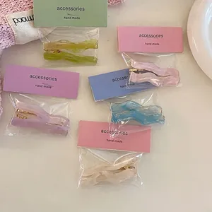 Five-piece wave resin hair clip set in pastel macaron colors with gold metal bases
