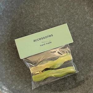 Detail of candy color wavy hair clips set in lime green and yellow resin finish
