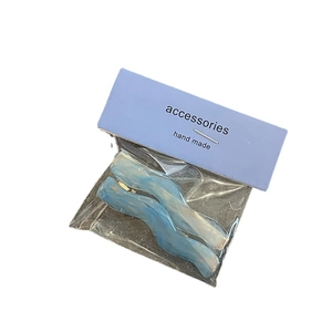 Set of two wavy candy color hair clips with blue and white marble texture on card