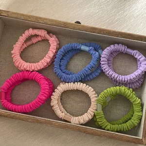 Set of 6 colorful pleated fabric hair ties in pastel colors presented in a jewelry box