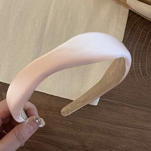 Pink satin padded headband with a smooth silky finish for women hair styling