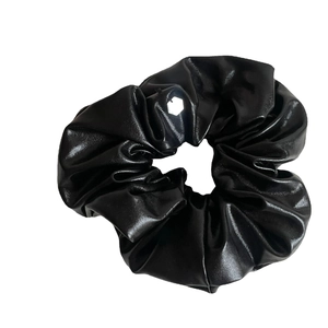 Chic black metallic bow hair scrunchie with shiny faux leather texture for women