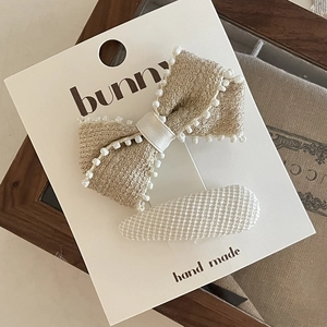 Cute beige tweed bow hair clip and white oval clip set on a handmade display card