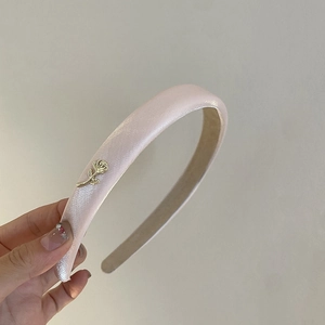 Elegant light pink satin headband with thick sponge padding and gold rose metal detail