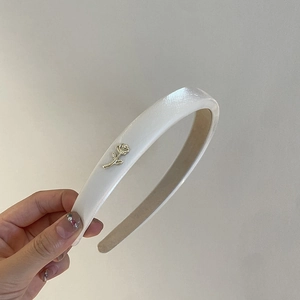 Elegant cream satin headband with metallic rose detail for a stylish high skull top look