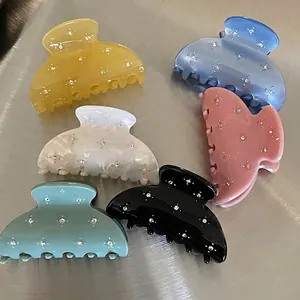 Set of six colorful semicircular hair claws with sparkling rhinestones on metallic base