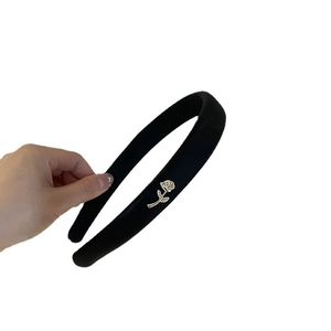 Elegant black satin padded headband with a gold rose metal detail for a retro look