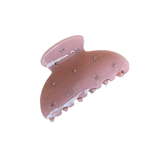 Pink semi-circle hair claw clip with sparkling rhinestones and a glossy finish