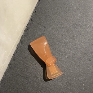 Detail einer lichtdurchlässigen orangefarbenen Haarklammer mit France Handmade Gravur