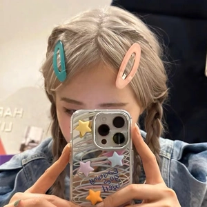 Candy color oval hair clips in pink and blue for women shown in a lifestyle selfie shot