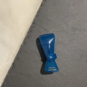 Detailansicht einer handgefertigten blauen transparenten Haarklammer mit Gravur