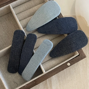 Denim star hair clip set with star and drop shapes in blue shades on linen display