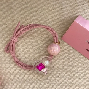 Pink elastic hair tie with pearl heart pendant and glittering rhinestone crystals