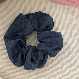 Vintage dark blue washed denim scrunchie with textured fabric and oversized ruffle design