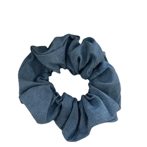 Vintage dark blue washed denim fabric scrunchie with pleated texture for daily hair styling