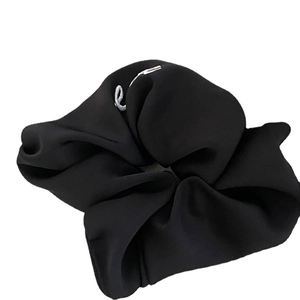 Large black satin scrunchie with french embroidery and silver accent on white background