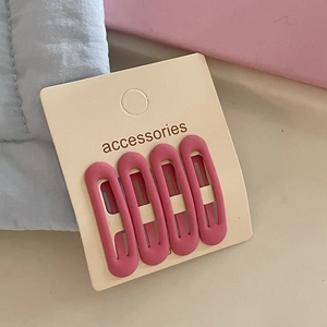 Pink matte oval hair clip set for girls displayed on card with pastel fabric background