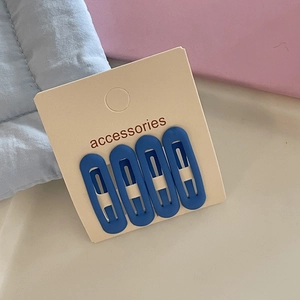 Set of four matte blue oval hair clips displayed on an accessories card for girls