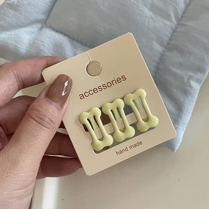 Three-piece set of cream bone-shaped hair clips for girls on display card