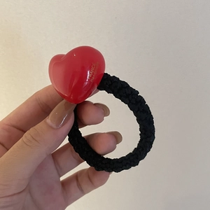 Detail of red jelly heart hair tie with France Handmade text and black woven band