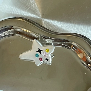 Star-shaped silver hair clip with colorful zircon stones and black star patterns