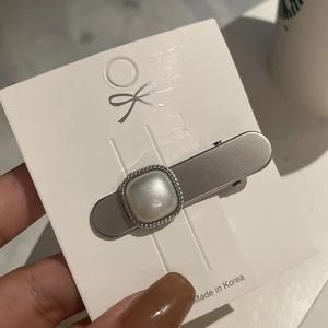 Detail of Korean style matte silver hair clip with square pearl and twisted metal border