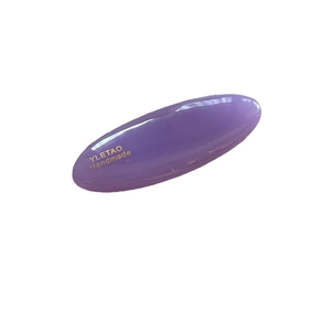 Simple purple oval hair clip in glossy resin with handmade gold branding on white background