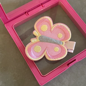 Cute embroidered pink butterfly hair clip presented in a protective 9x9cm square display box