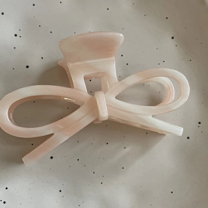 Elegant peach acetate bow hair claw clip with marble texture for French style hairstyle
